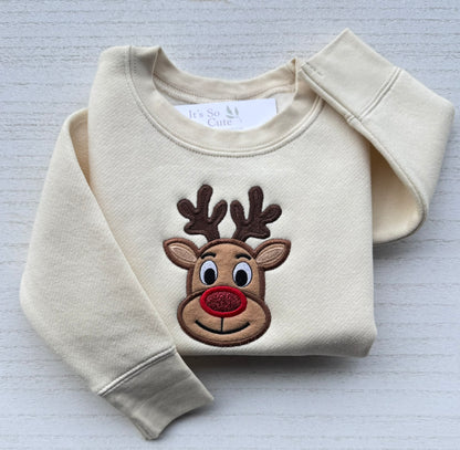 Detailed close-up of professional reindeer embroidery showing the antlers, stitched eyes and red glitter nose.