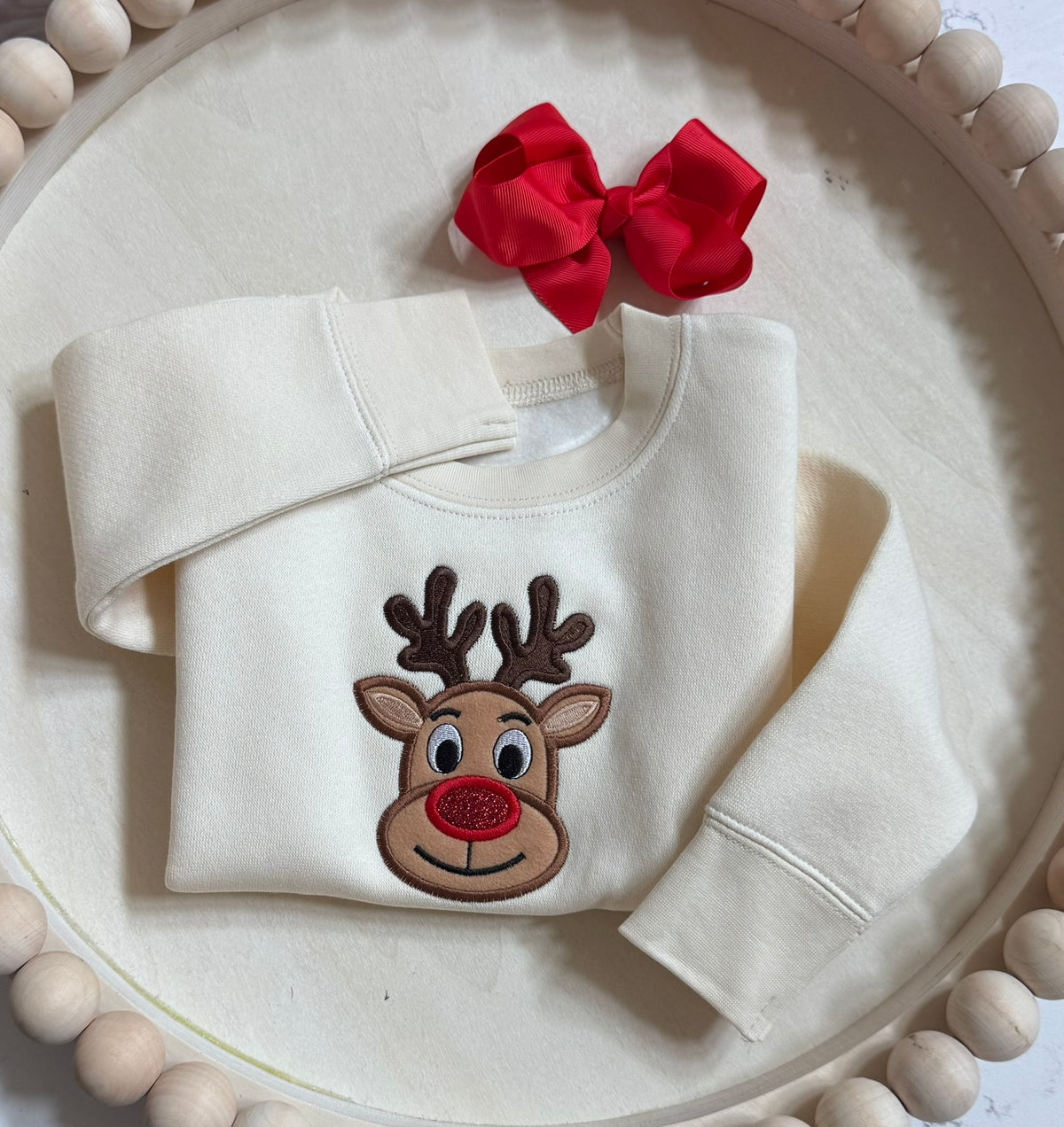 Nature reindeer Christmas sweatshirt displayed with an optional matching red grosgrain hair bow.