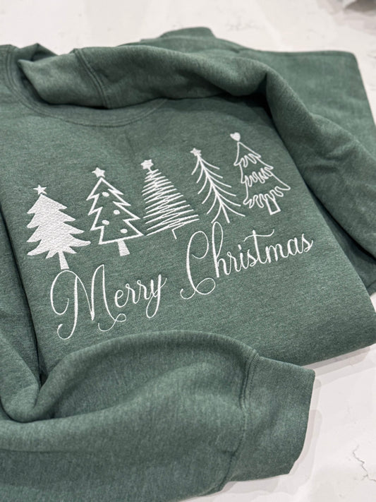 Close-up of white thread Christmas tree embroidery on holiday sweatshirt