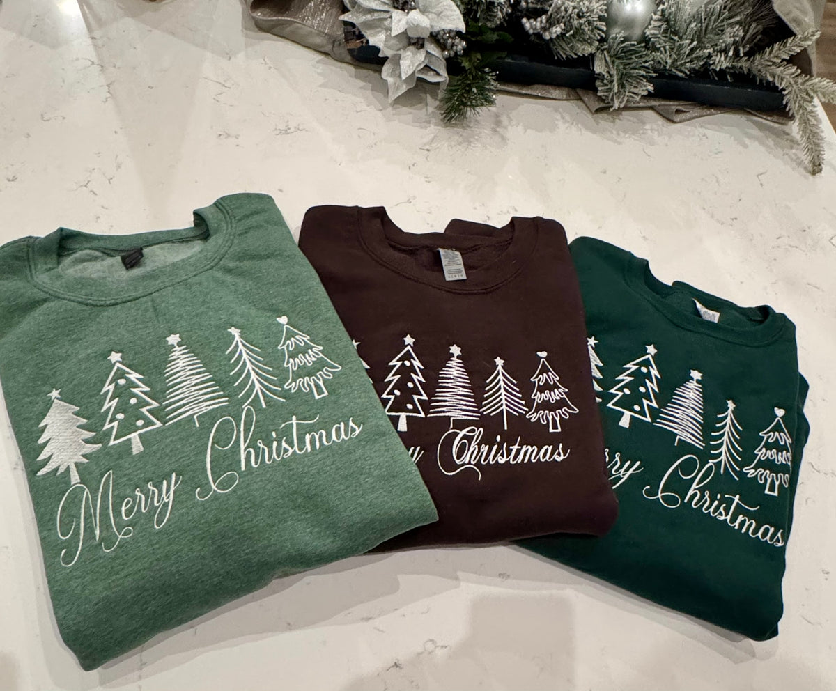 Three Minimalist Christmas tree sweatshirts with white embroidered Merry Christmas lettering