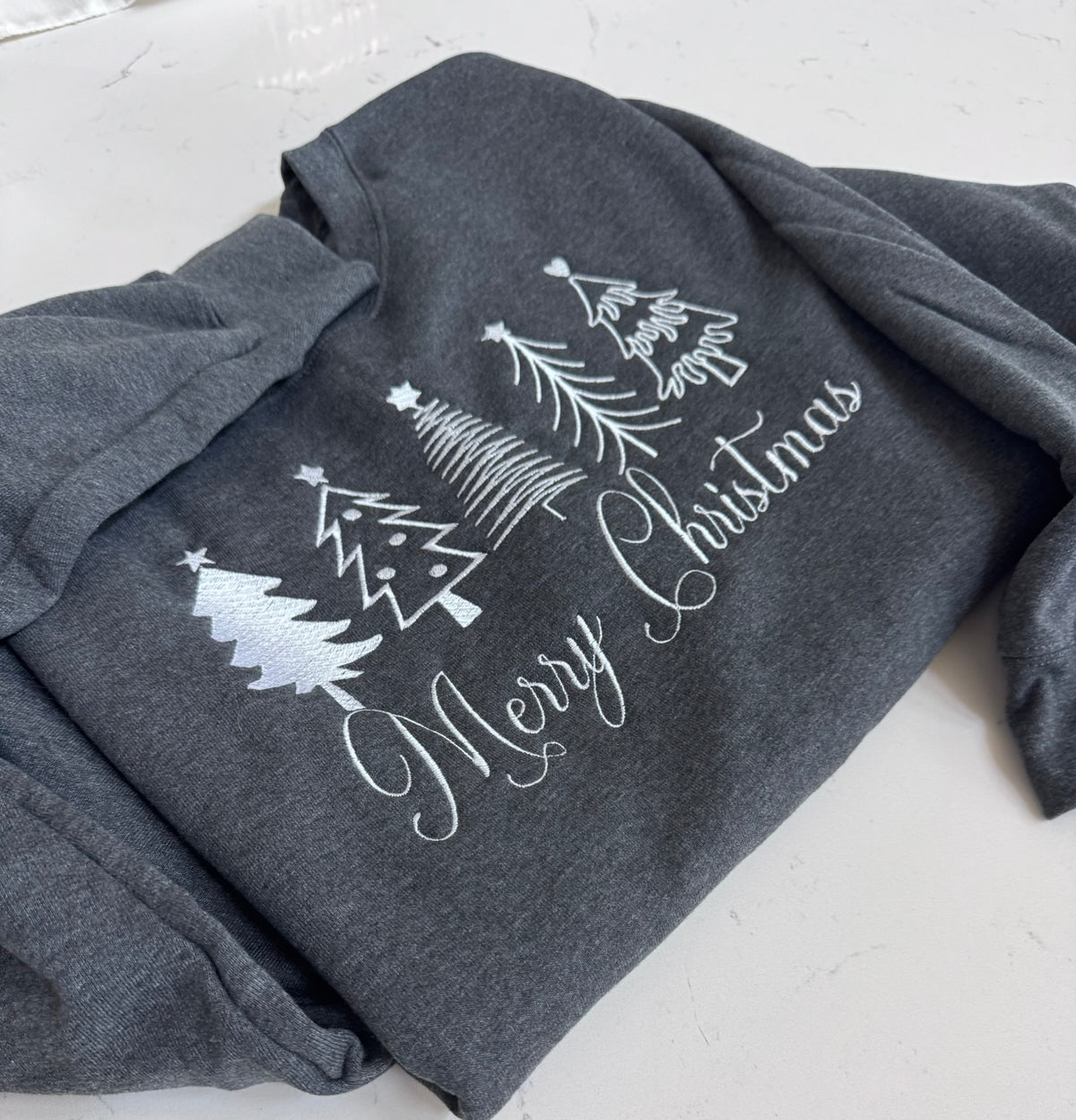 Merry Christmas embroidered sweatshirt with minimalist white Christmas tree design