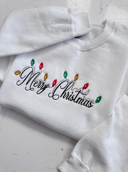 Merry Christmas embroidery on white crewneck sweatshirt with holiday lights