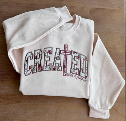 Close-up of With a Purpose embroidered on the sweatshirt sleeve