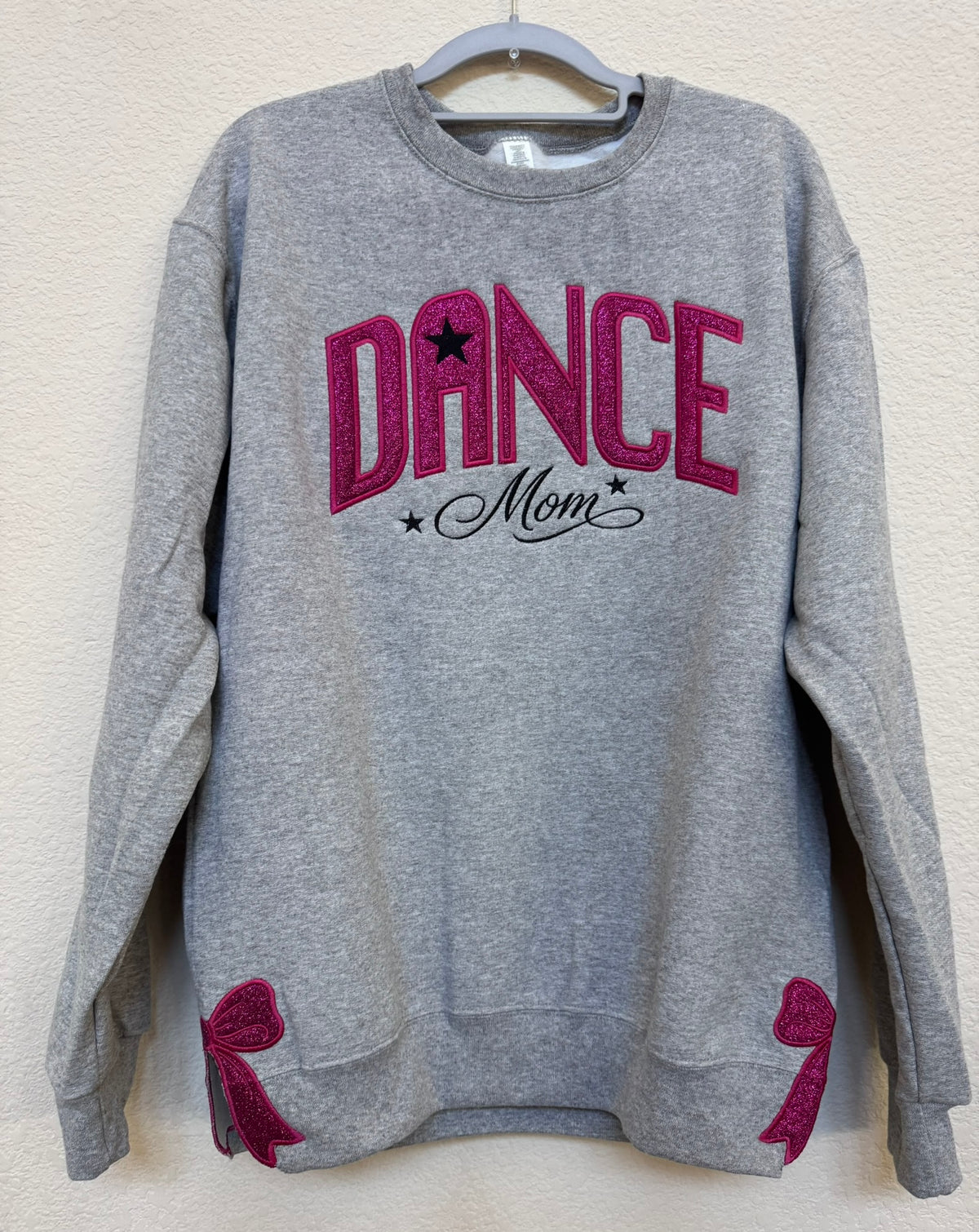 Dance sparkle appliqué being embroidered on a sweatshirt