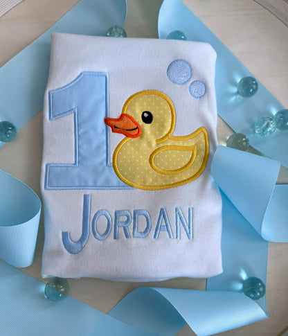 Personalized first birthday outfit with embroidered duck and custom number