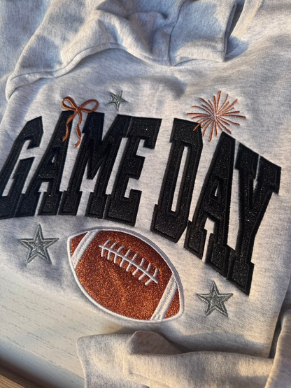 Close-up of embroidered GAME DAY lettering with glitter football and sparkle stars