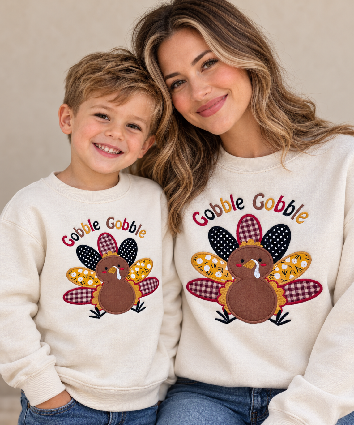 Mother and child wearing matching cream Gobble Gobble embroidered turkey sweatshirts for a cozy family Thanksgiving outfit.