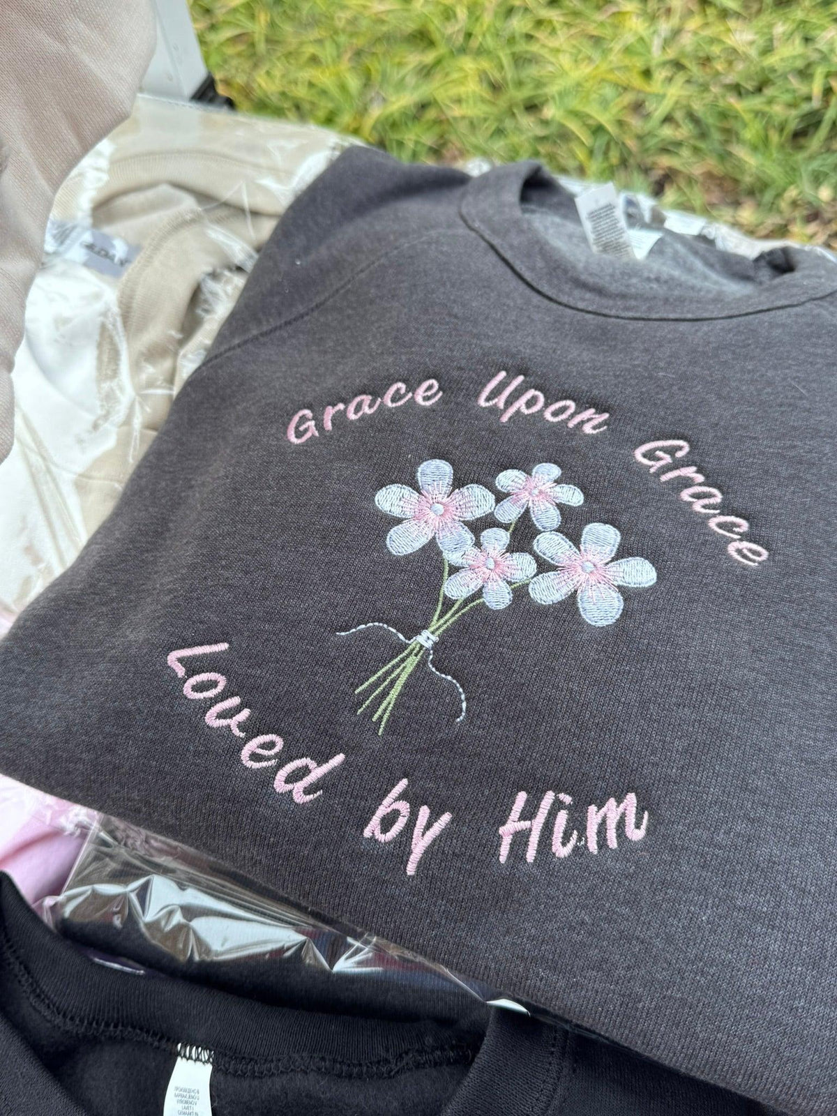 Close-up of Grace Upon Grace Christian embroidery detail on faith sweatshirt