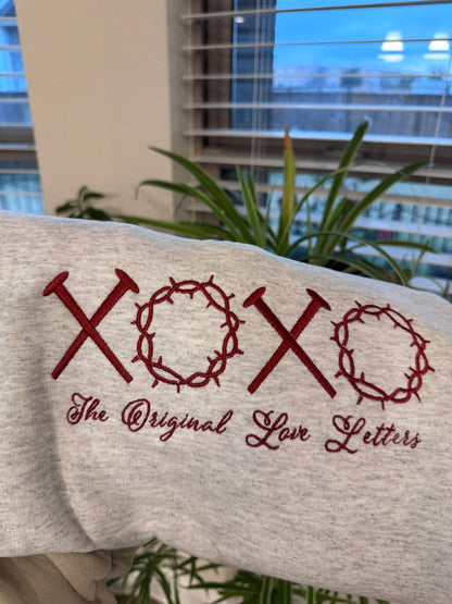 Close-up of XOXO embroidery with nails and crowns design Christian sweatshirt