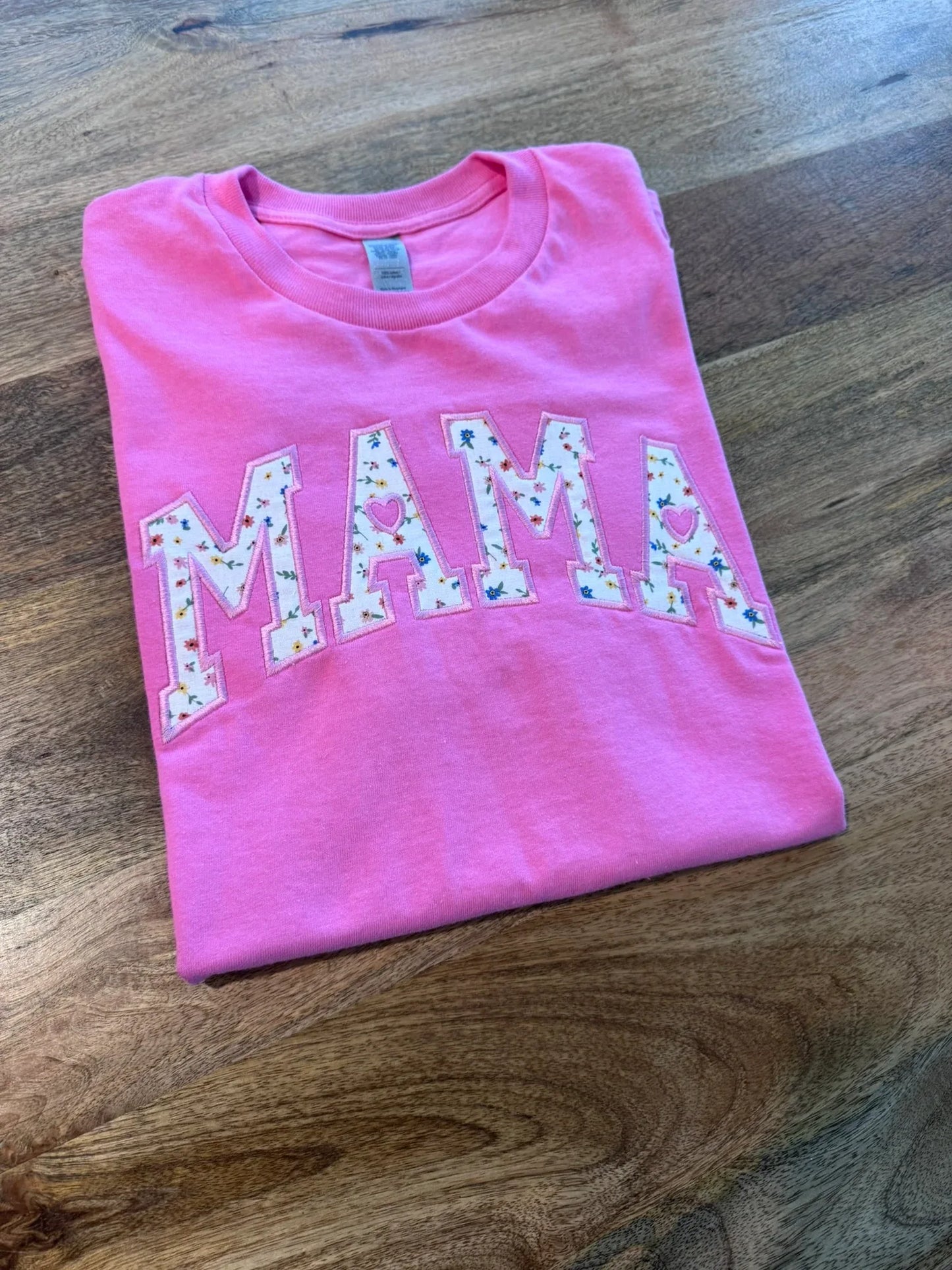 Detail of personalized name embroidery on floral Mama shirt