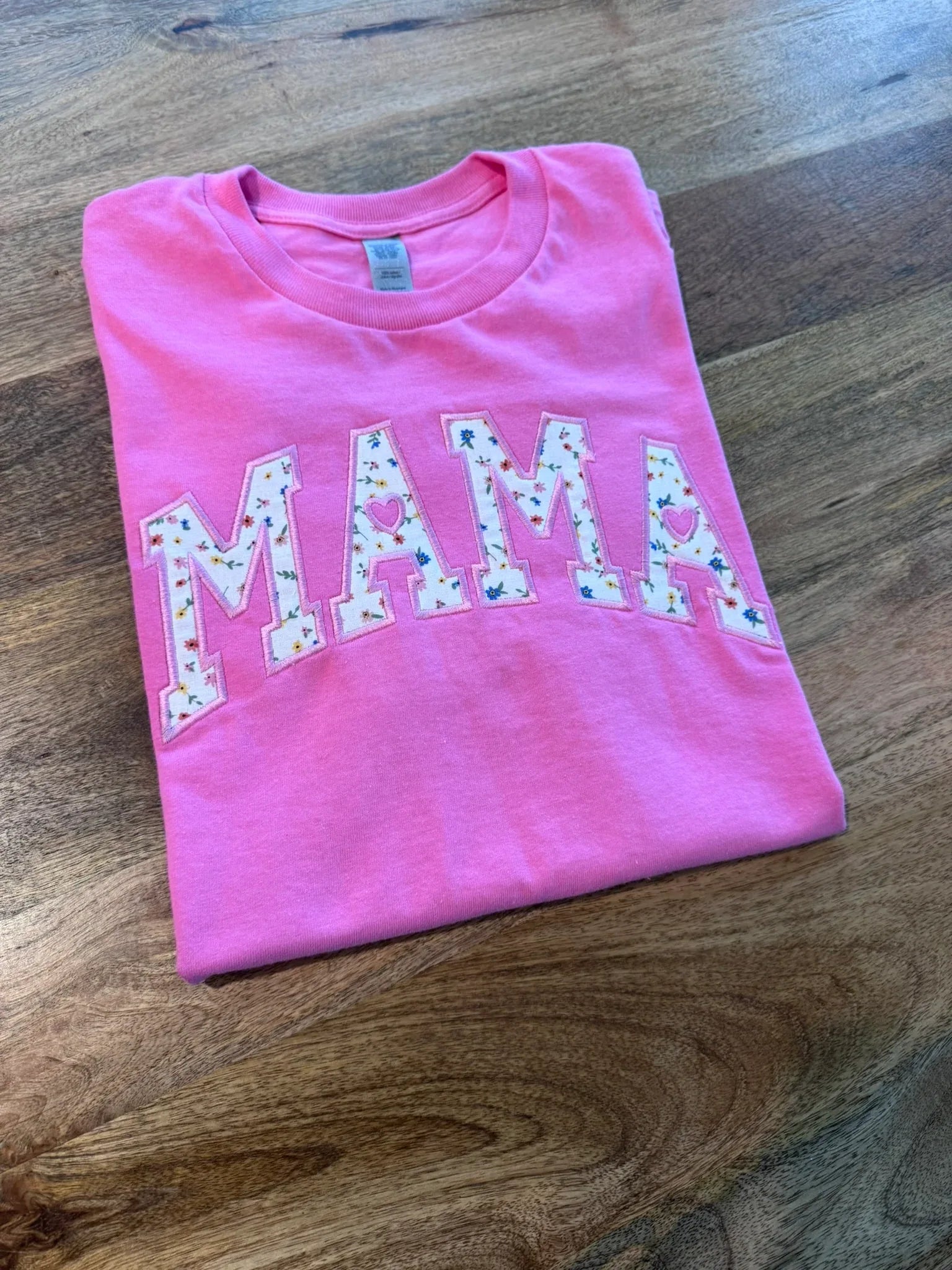 Detail of personalized name embroidery on floral Mama shirt