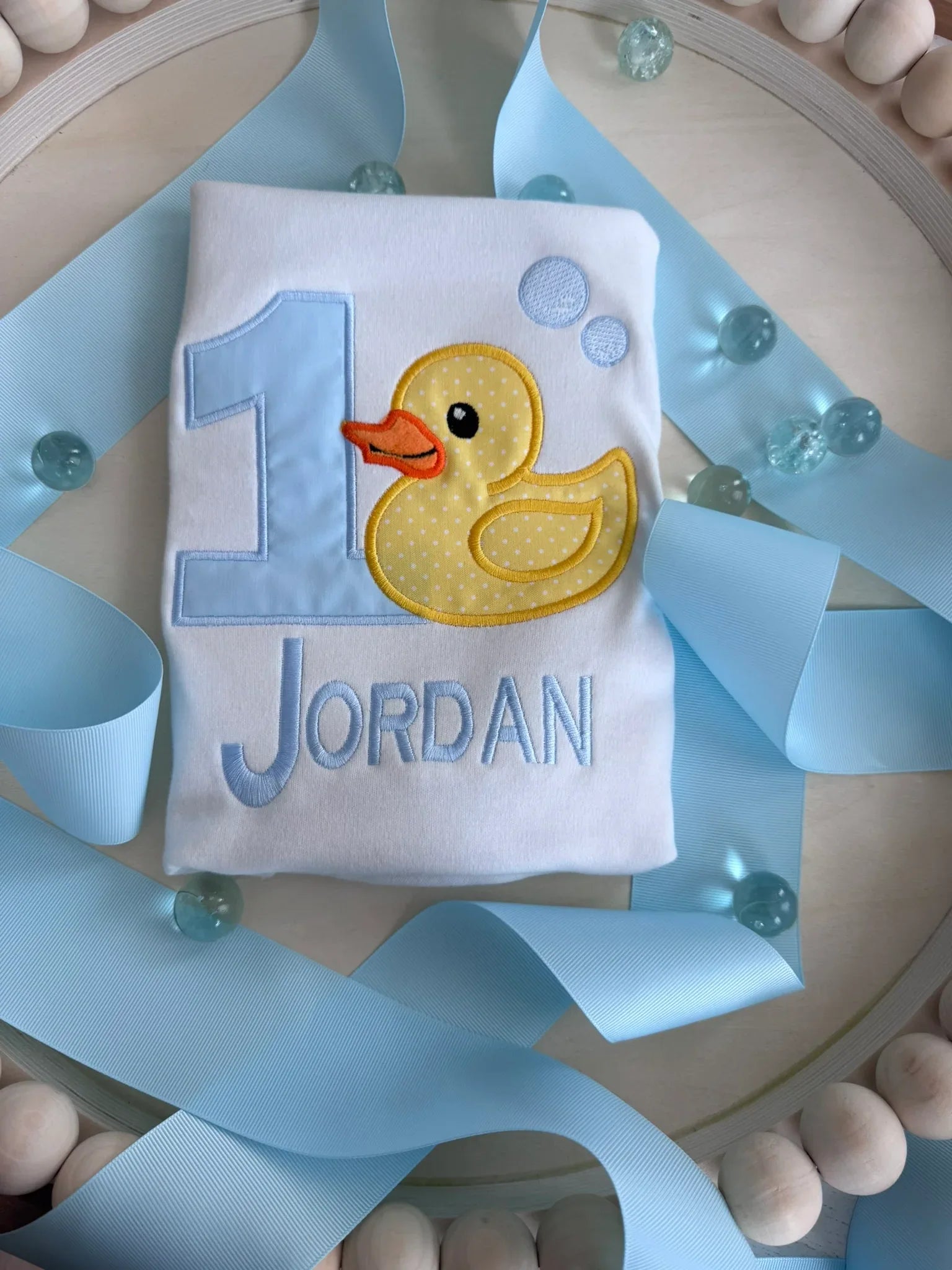 Close-up of duck design on personalized first birthday custom name shirt