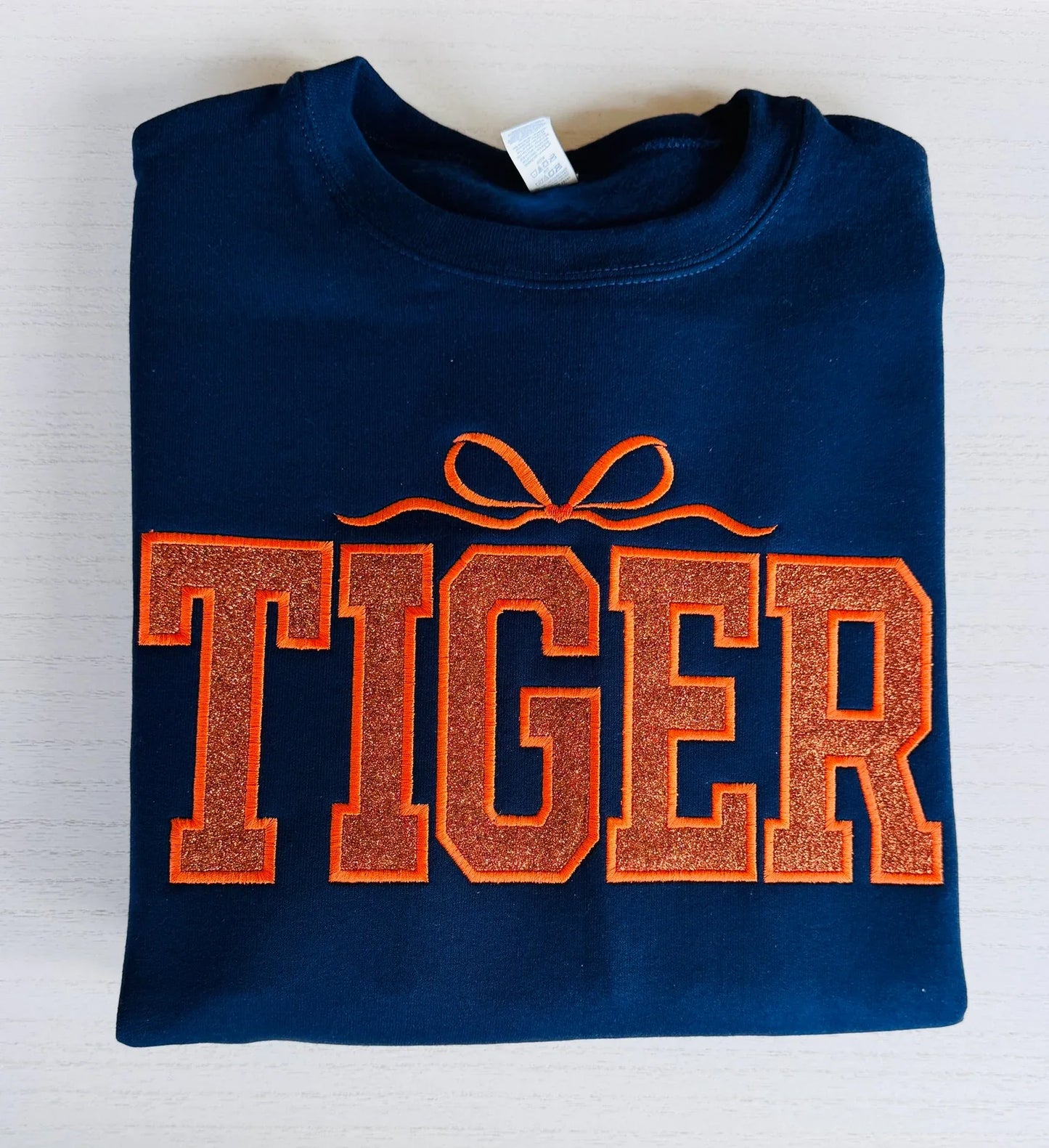 Detail of sparkle varsity tiger embroidered crewneck sweatshirt