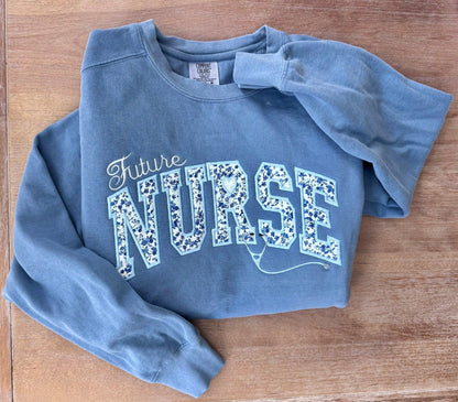 Future Nurse embroidered sweatshirt in blue with floral lettering detail