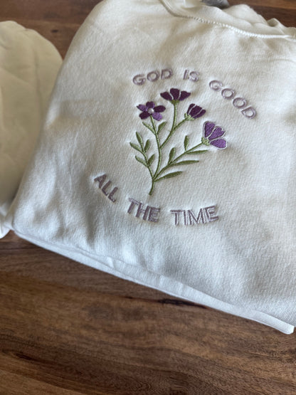 Close-up of floral embroidery on God Is Good All The Time Christian sweatshirt