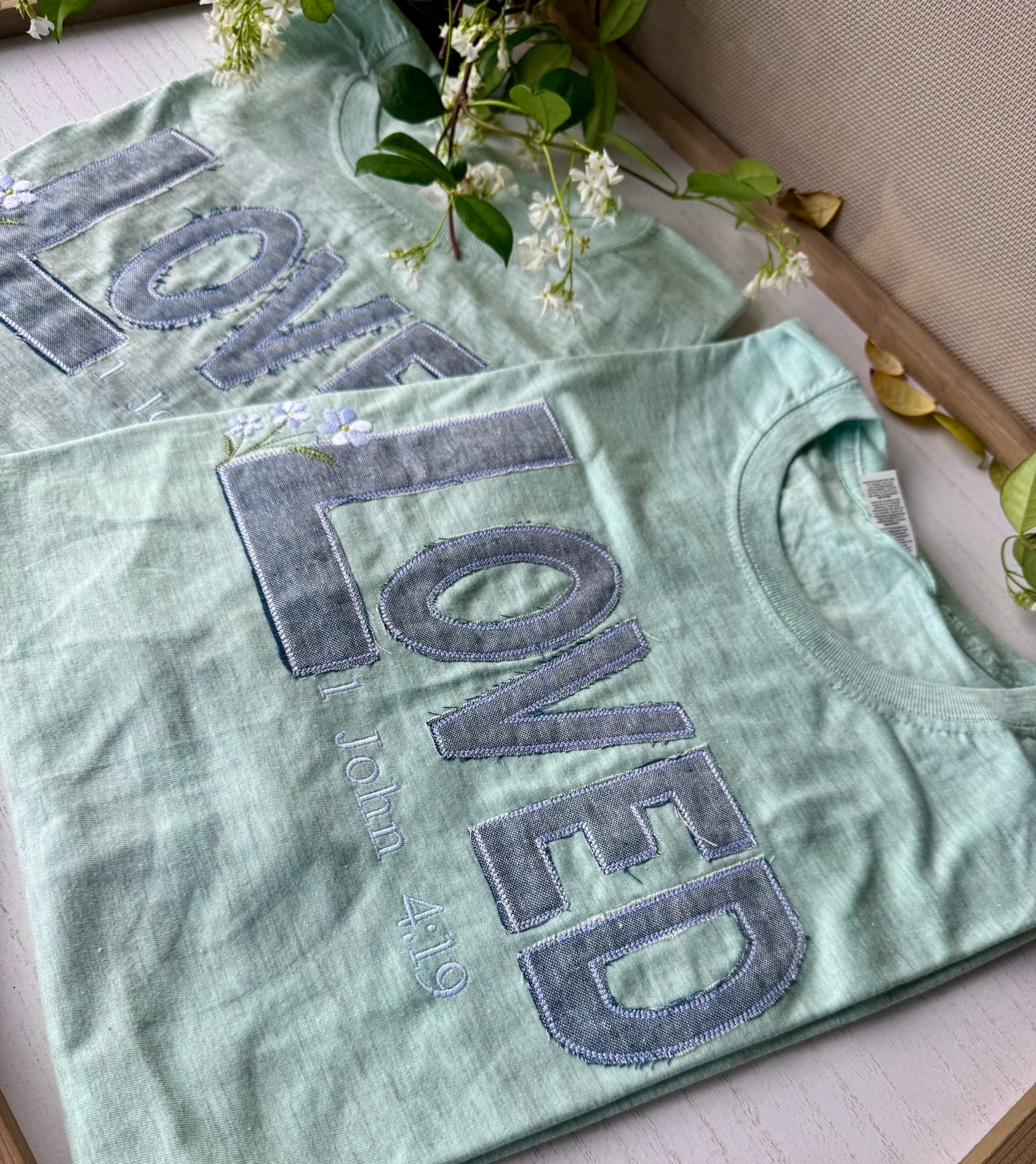 LOVED tee — frayed denim appliqué detail showing white and blue threads