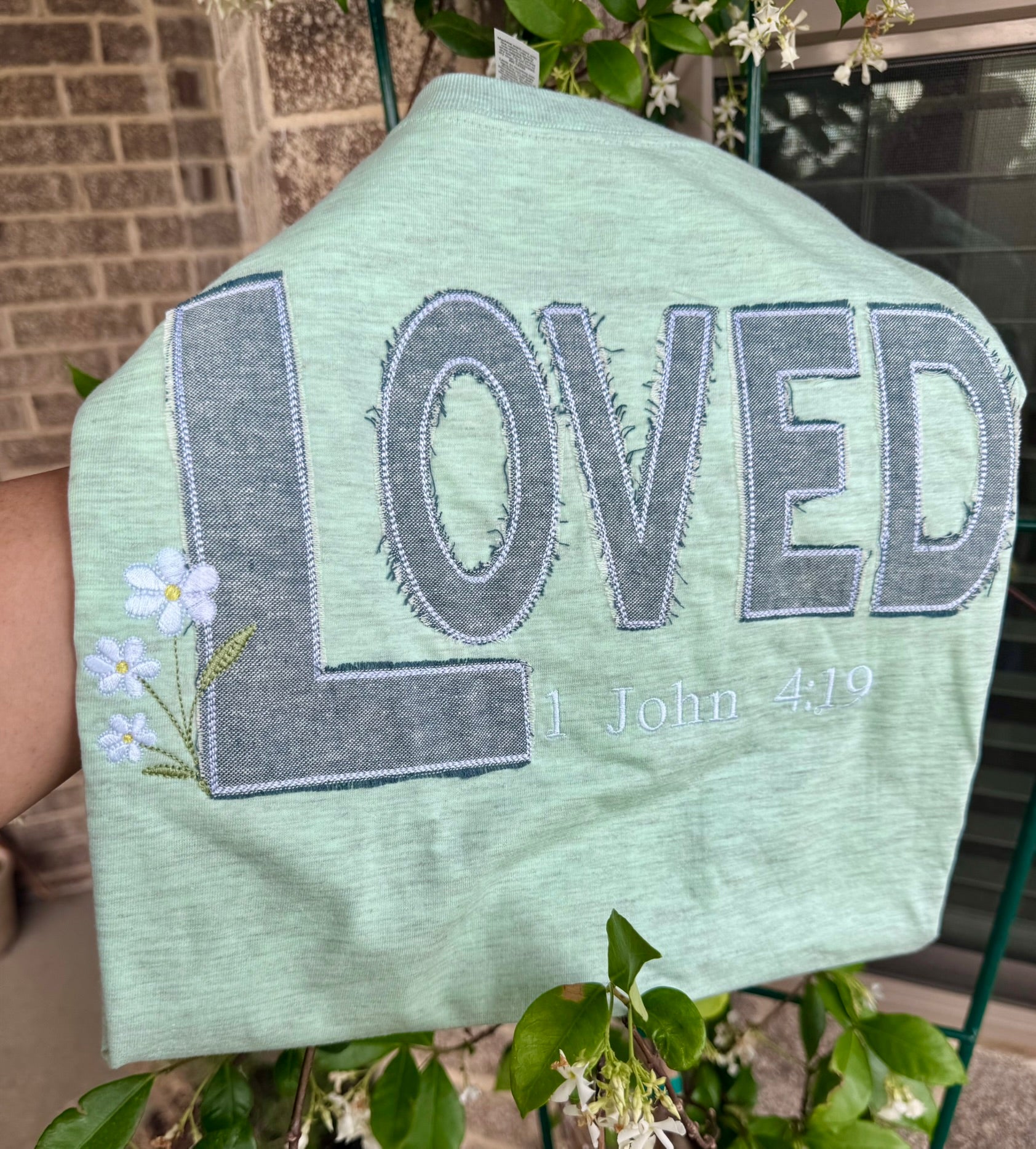 Floral embroidery detail on LOVED heather mint tee