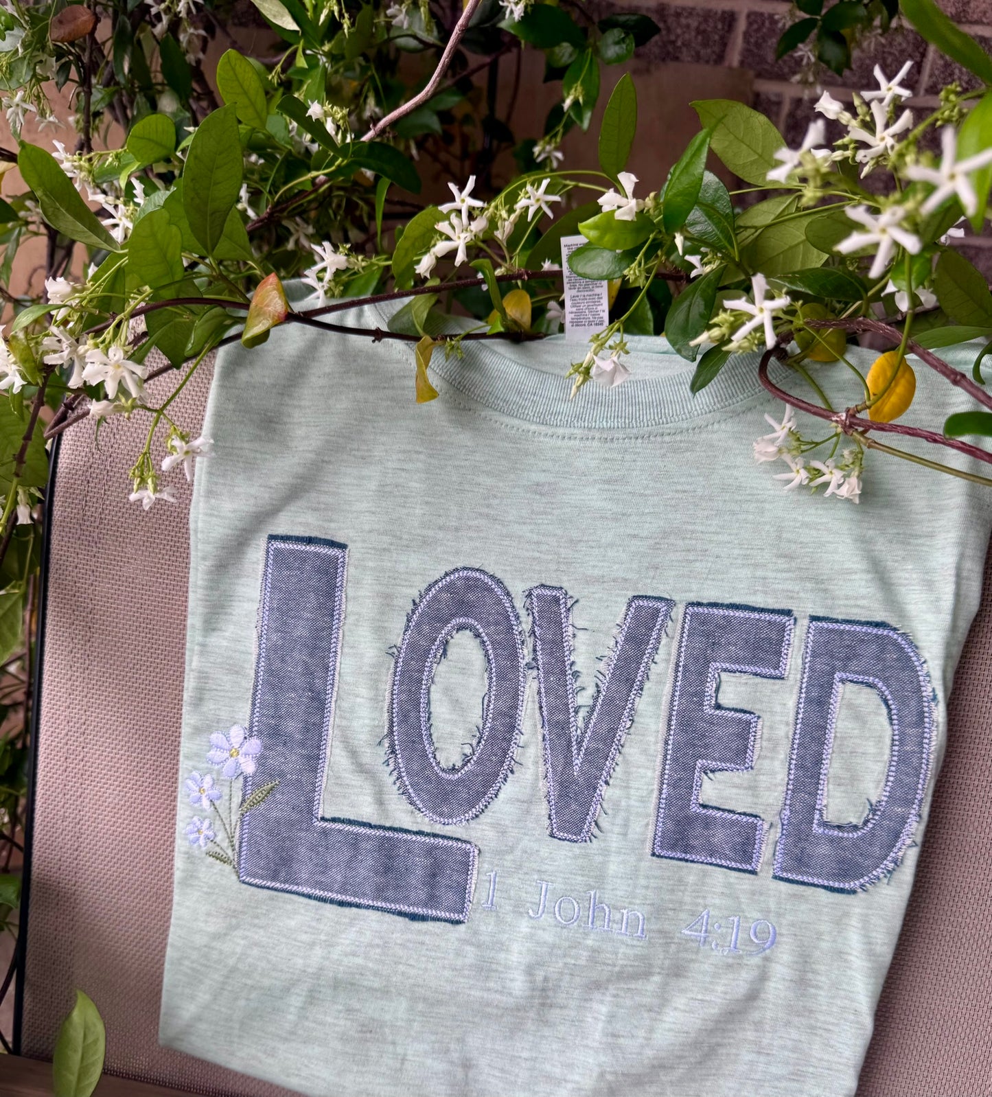 LOVED denim appliqué tee — handcrafted embroidery with frayed blue and white threads