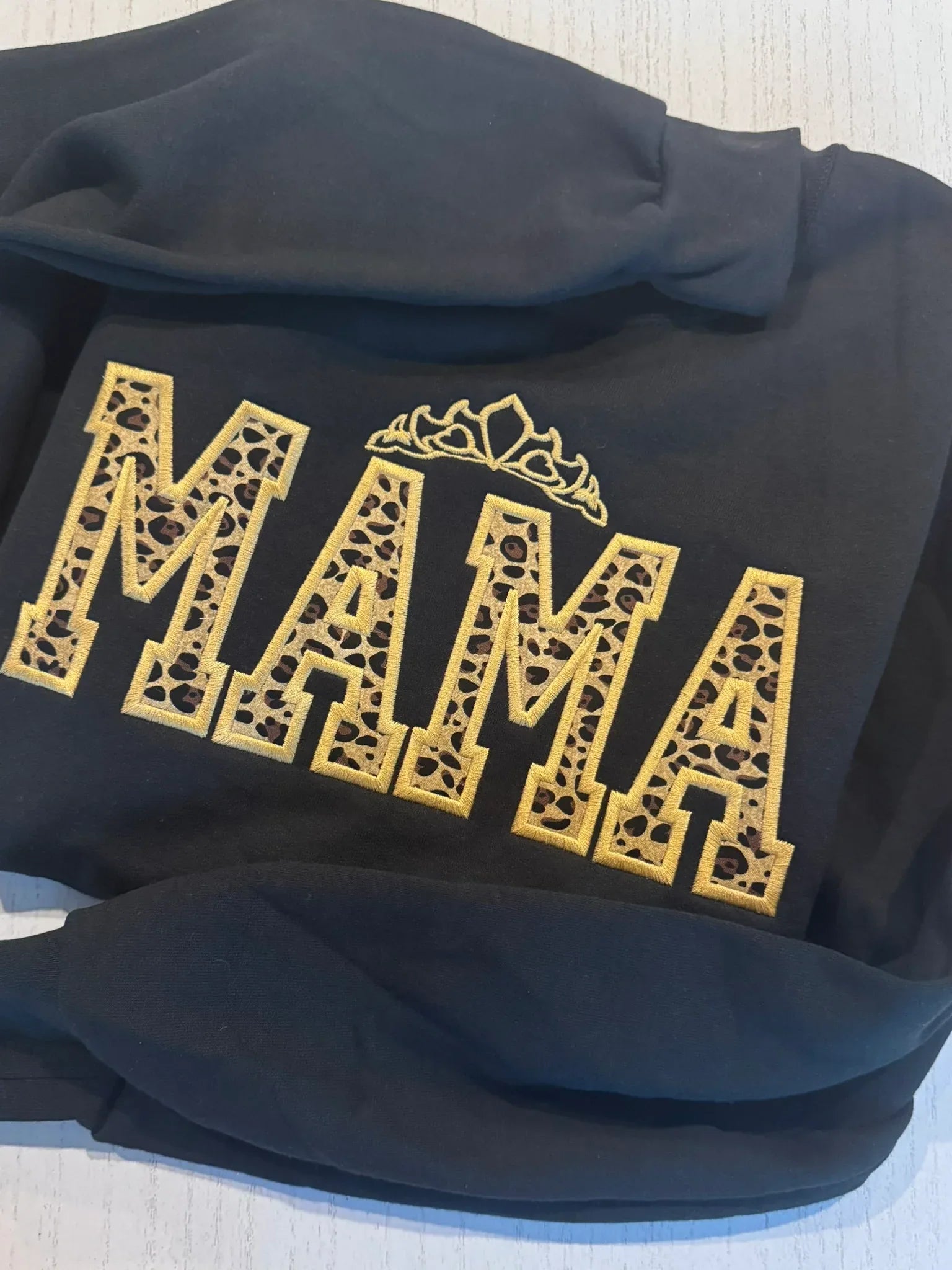 Black hoodie with 'MAMA' in  leopard embroidered applique with gold crown 
