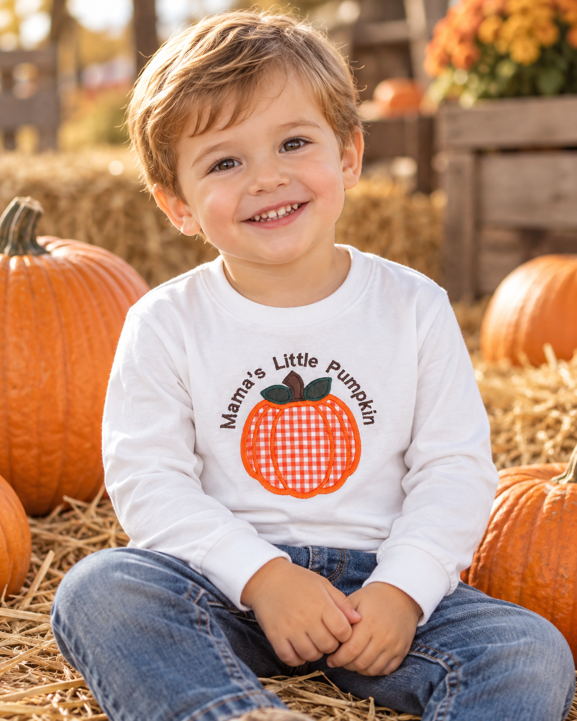 Toddler wearing personalized Mama’s Little Pumpkin embroidered shirt at a fall pumpkin patch