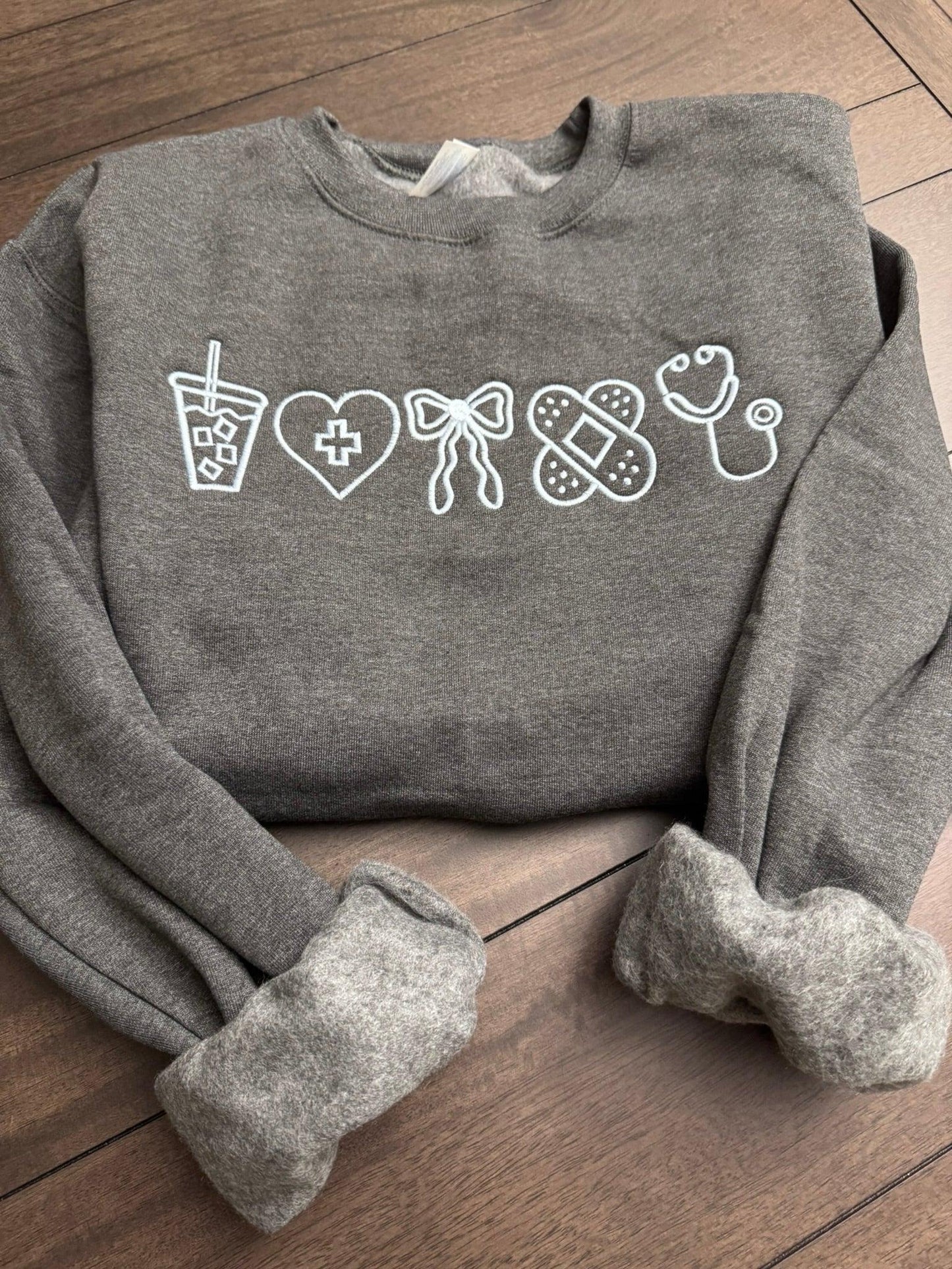 Gray sweatshirt with white graphic designs for nurse