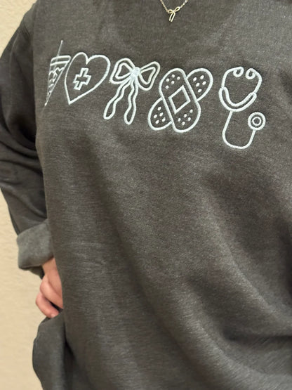 Gray sweatshirt with white graphic designs on a beige background