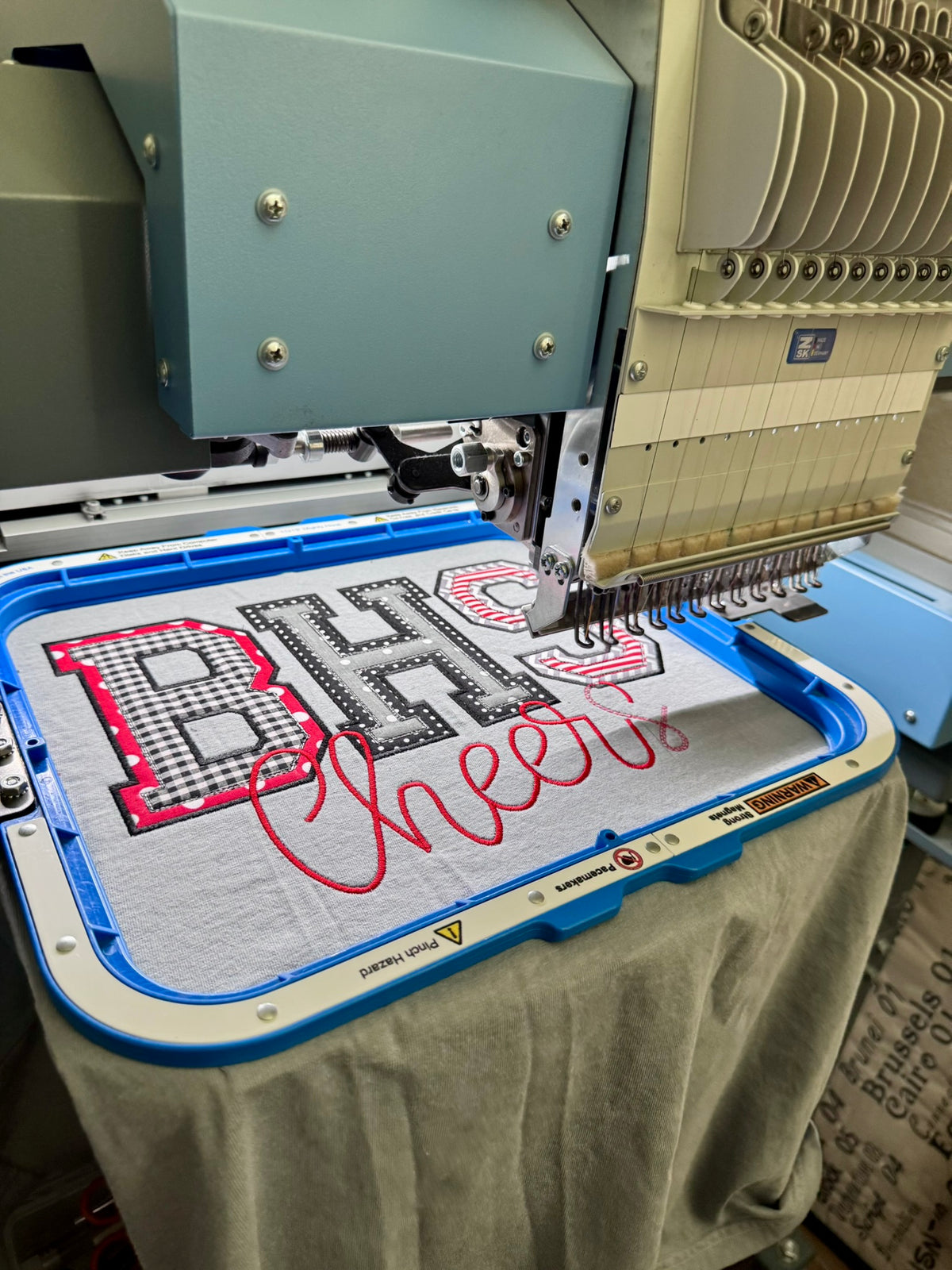 Close-up of custom BHS applique embroidery showing layered fabrics, stitching and handmade school spirit design.