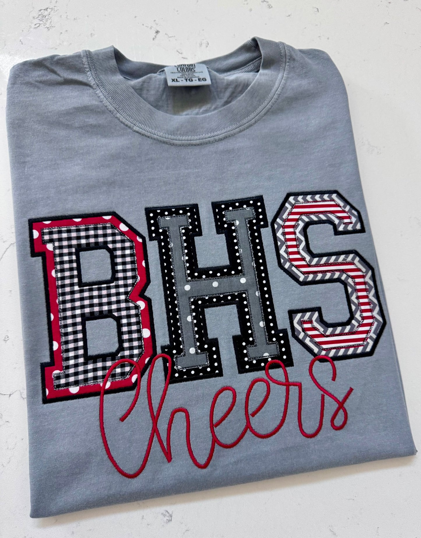Custom BHS school initials applique Comfort Colors shirt with red, black, white and gray embroidered fabric design and Cheers script.