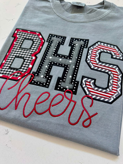 Folded custom BHS school spirit applique shirt in red, black, white and gray with Cheers embroidery.