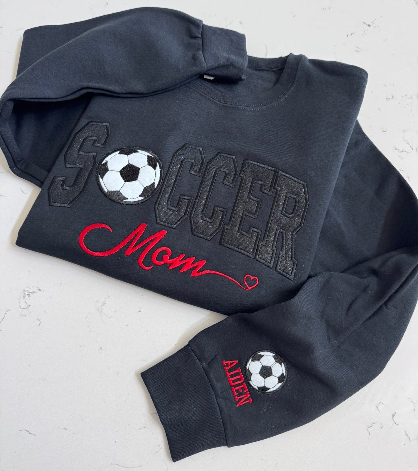 Black Soccer Mom sweatshirt with optional embroidered sleeve detail
