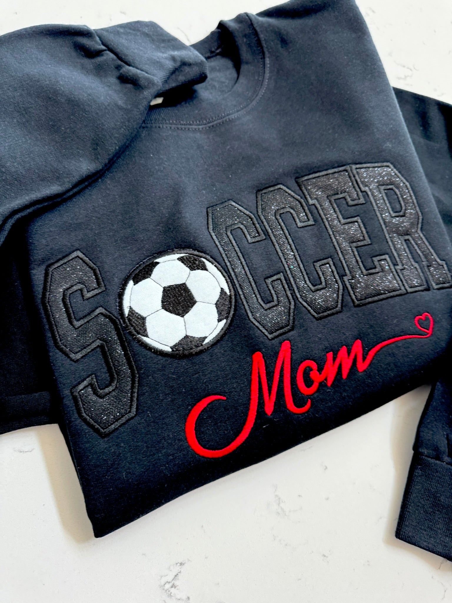 Black soccer sweatshirt with tonal sparkle appliqué and custom red Mom title