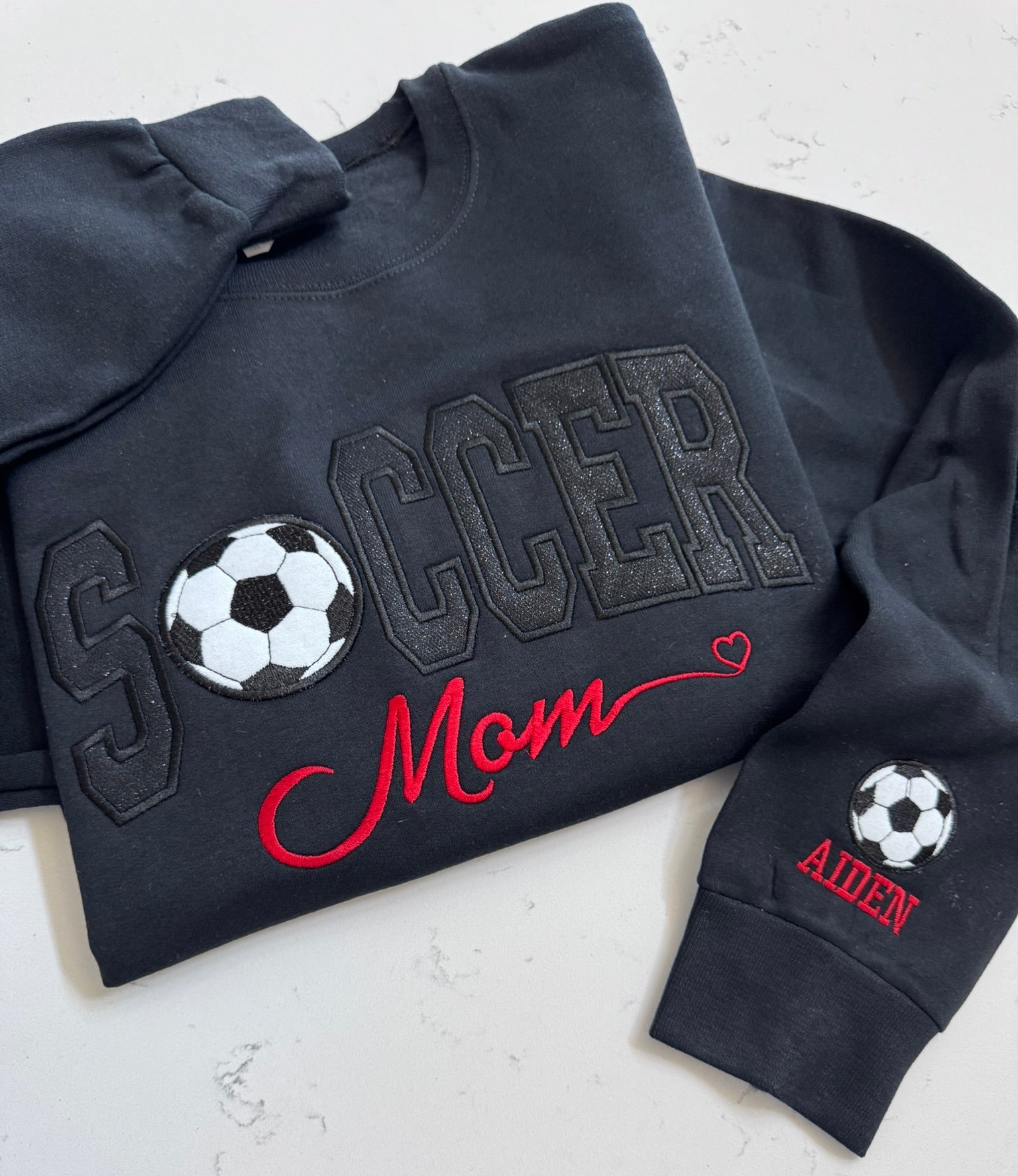 Blackout Soccer Mom sweatshirt with black sparkle appliqué and red embroidery