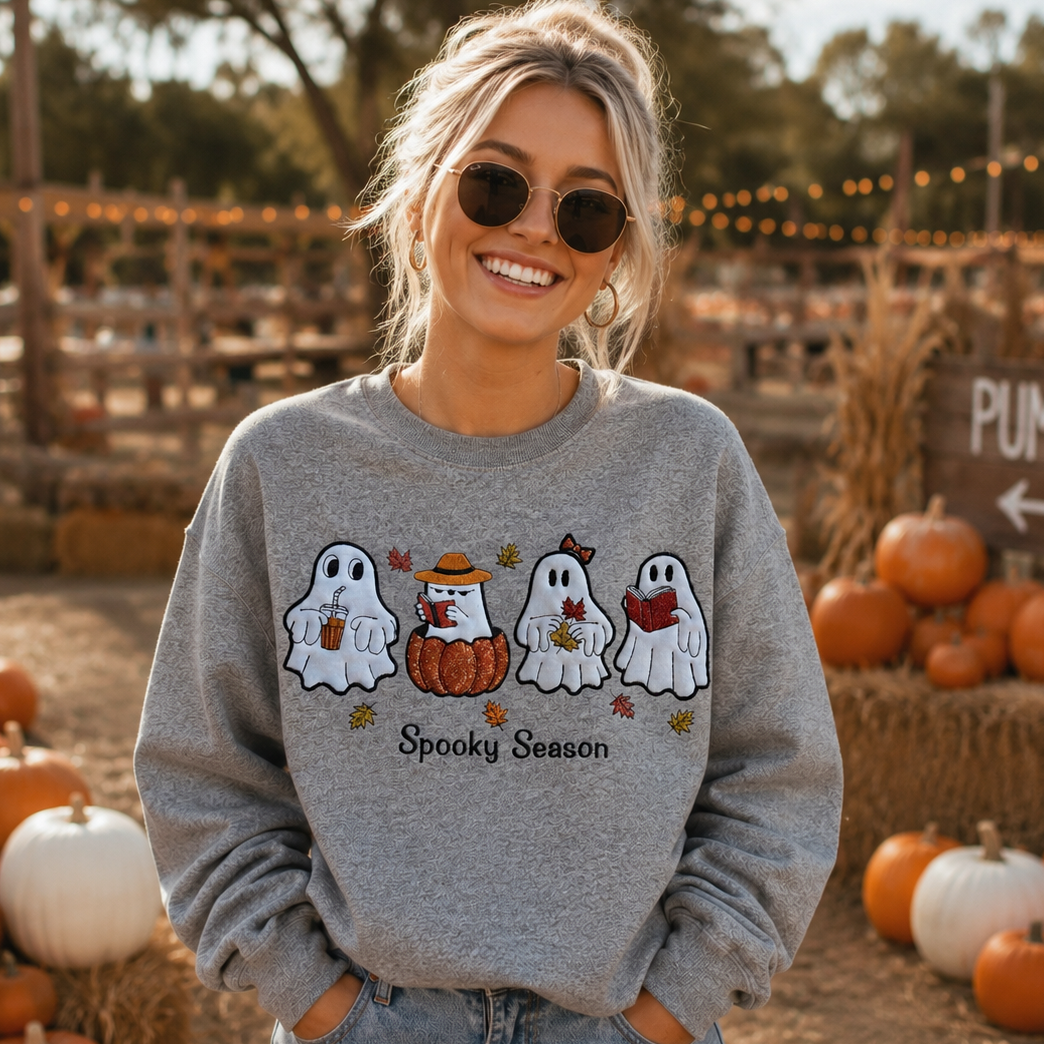 Woman wearing an embroidered Spooky Season ghost sweatshirt outdoors in fall
