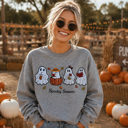 Woman wearing an embroidered Spooky Season ghost sweatshirt outdoors in fall