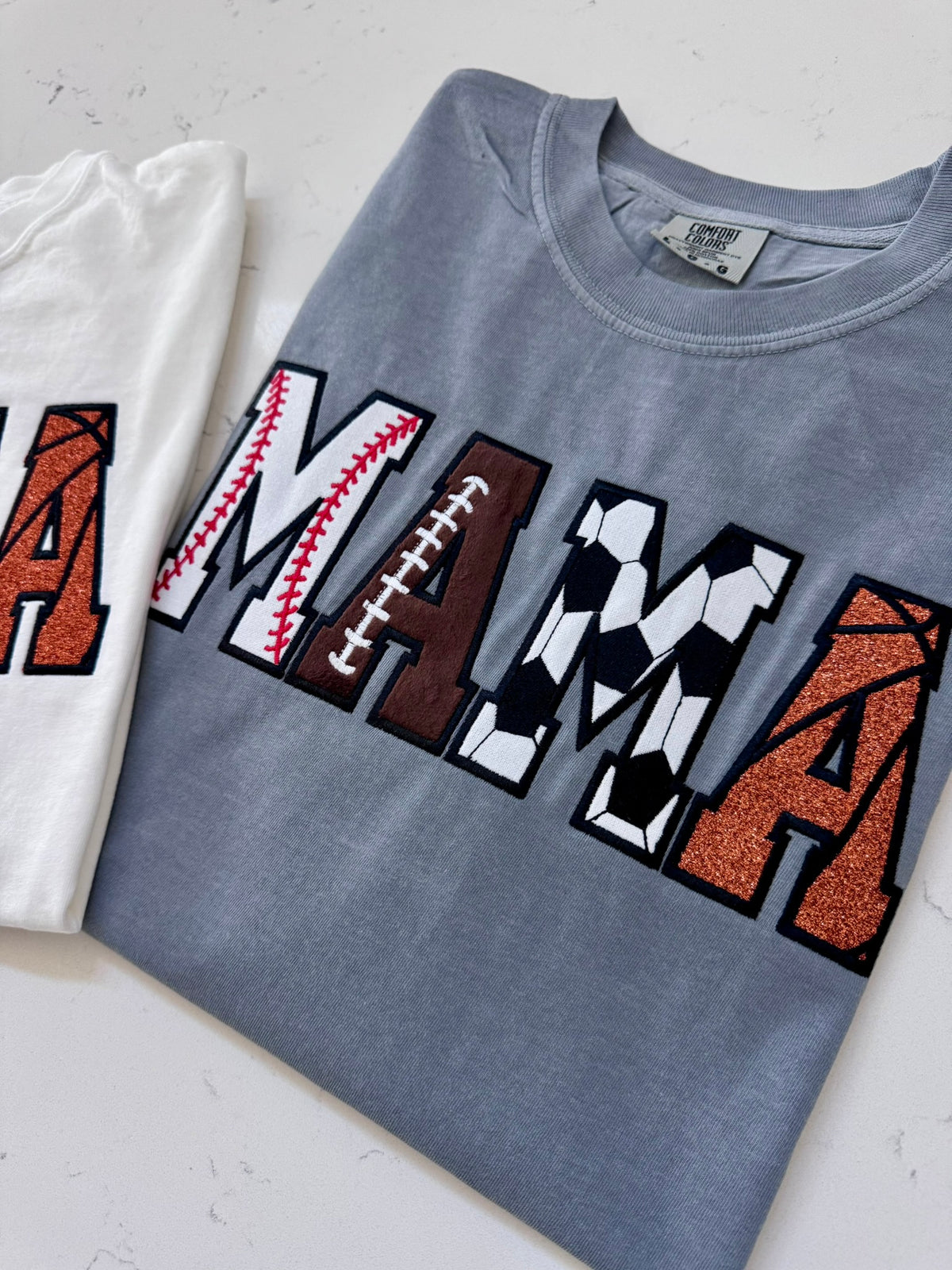 Close-up of baseball football soccer and basketball details in the MAMA appliqué design