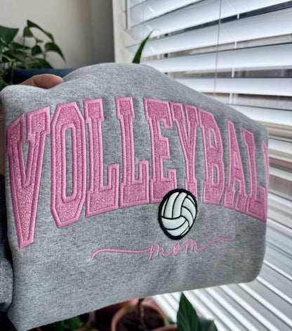 Gray sweatshirt with pink 'VOLLEYBALL mom' text and volleyball design, personalized with name