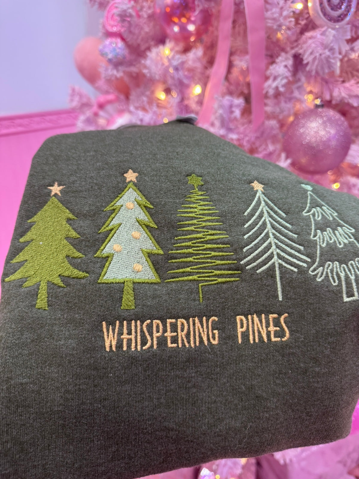 Full view of forest green heather crewneck sweatshirt with premium pine tree embroidery