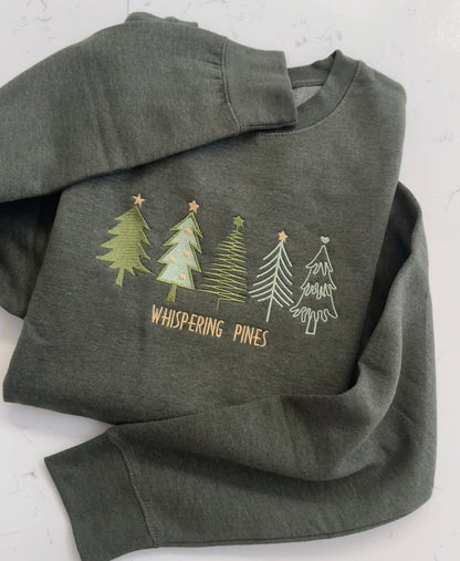 Whispering Pines embroidered winter sweatshirt featuring five evergreen tree designs