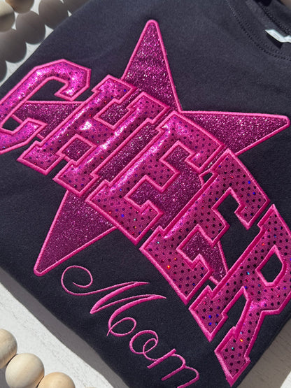 Close-up of dual-fabric pink sparkle appliqué on personalized Cheer sweatshirt