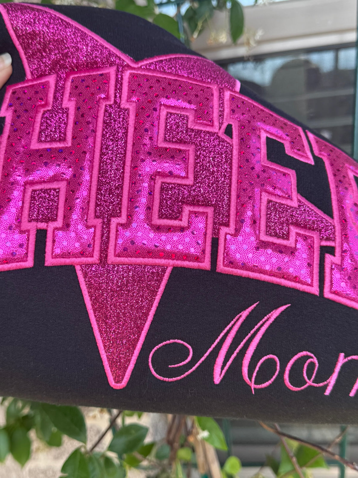 Close-up of contrasting sparkle textures used in the CHEER appliqué design